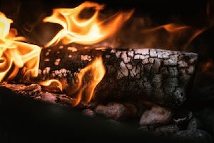 Wood burning in a fireplace producing smoke